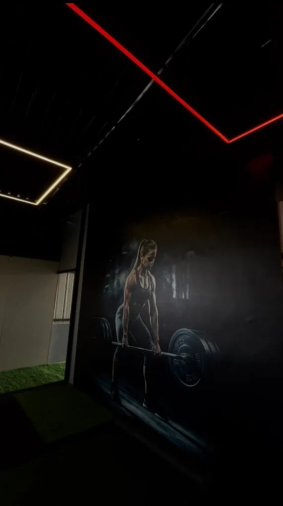 Deadlift mural and red lighting inside JP Fitness