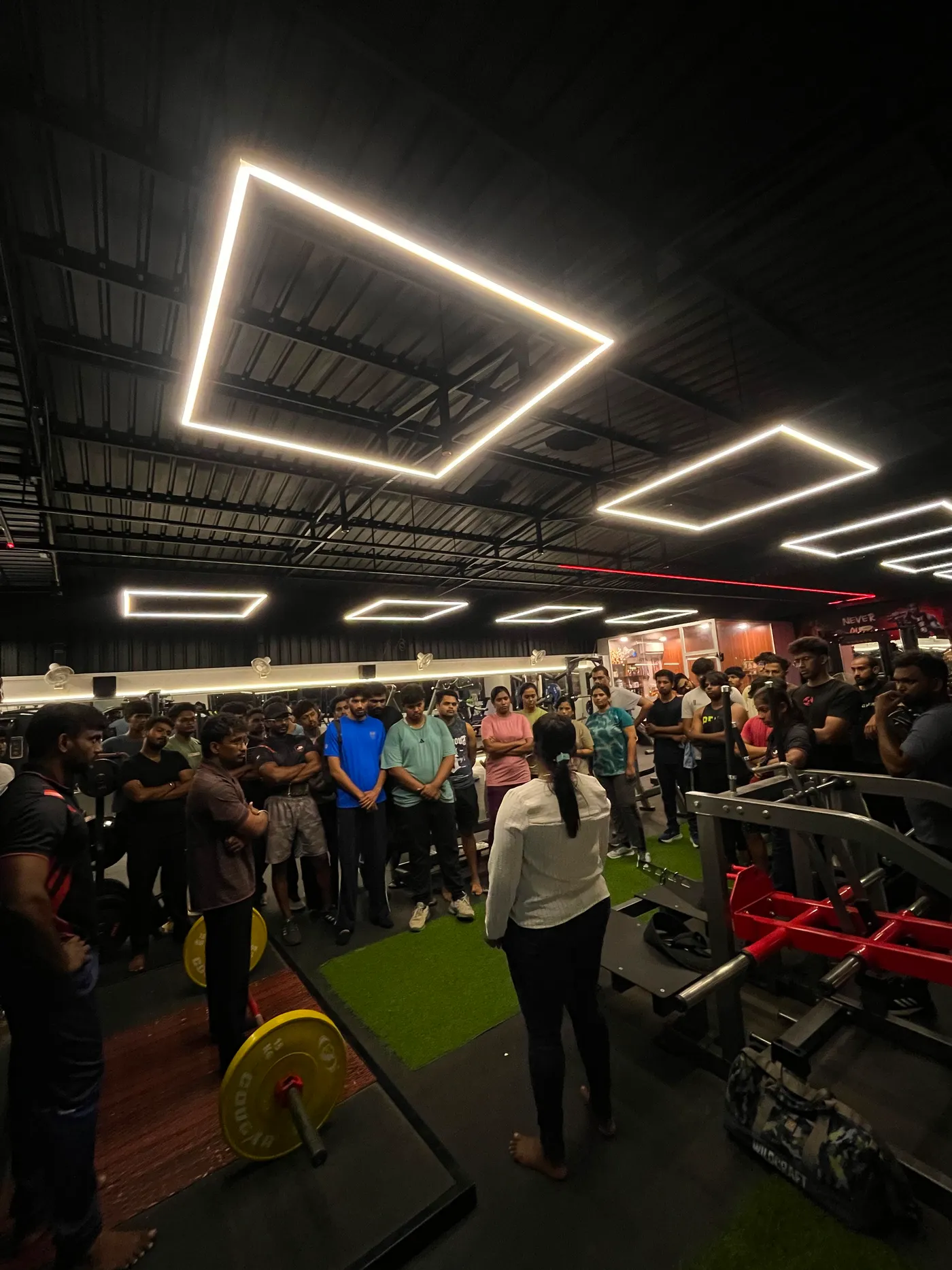 Members watching a lifting demonstration at JP Fitness